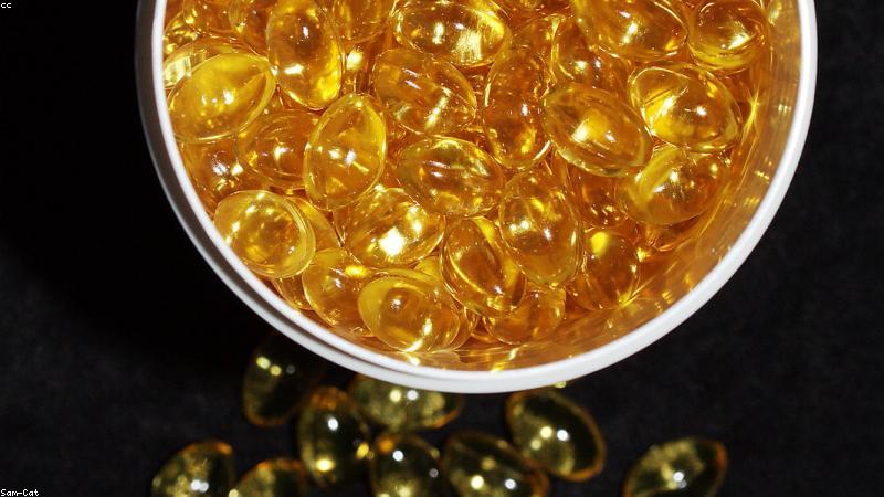 omega 3 fish oil capsules and healthy heart concept