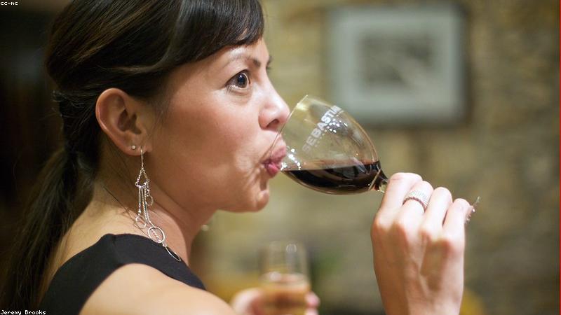 person drinking glass of water fresh fruits