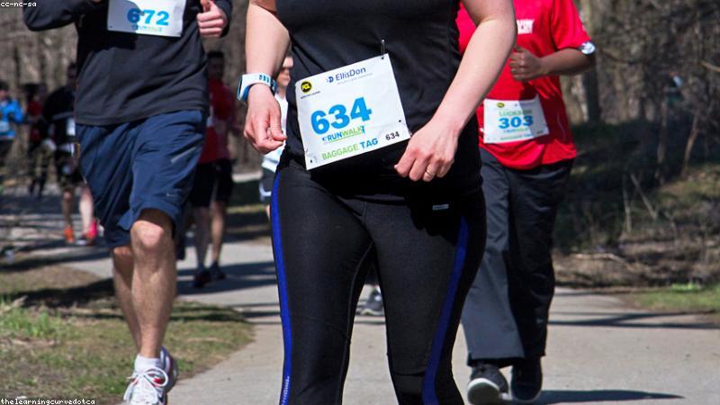 woman jogging outdoors with headphones