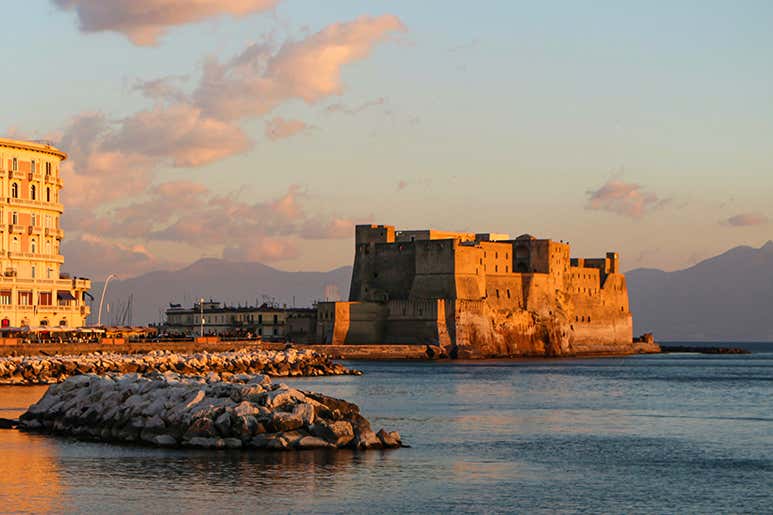 Naples Italy Castel dell'Ovo seafront sunset 2026 모습